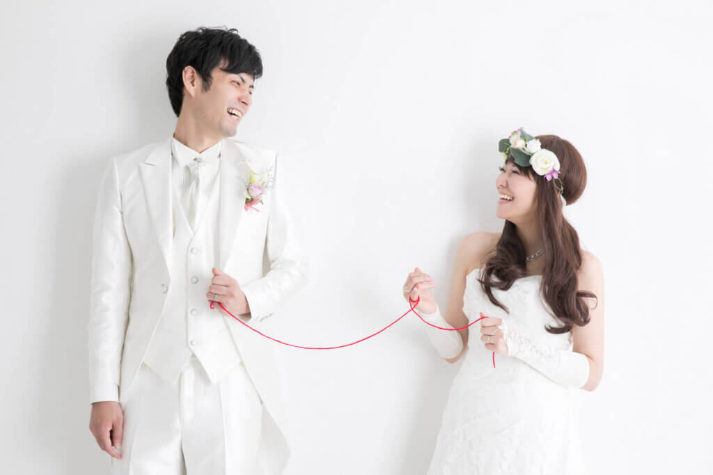 赤い糸で結ばれた新郎新婦