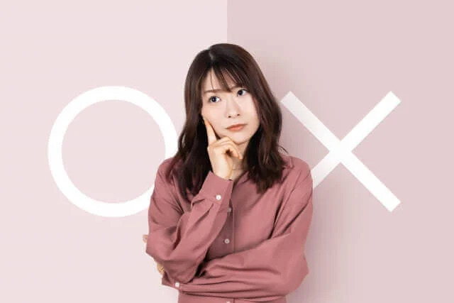 ◯と×の背景を前に悩み顔の女性