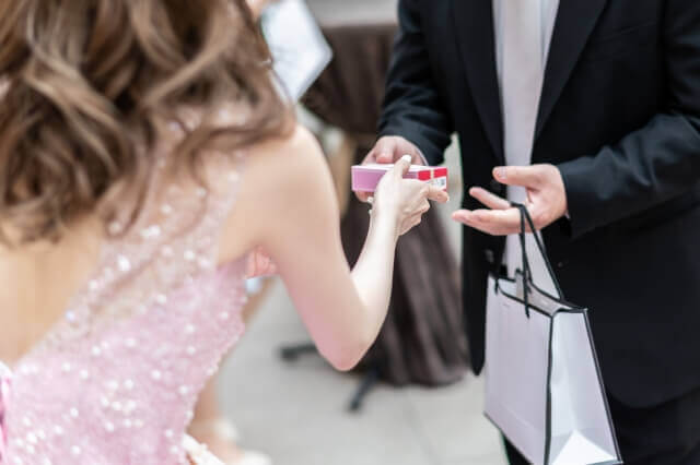 新婦が出席したゲストにプチギフトを渡している