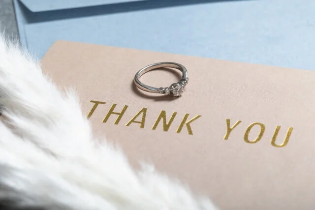 「THANK YOU」と書かれた感謝のカードと結婚指輪